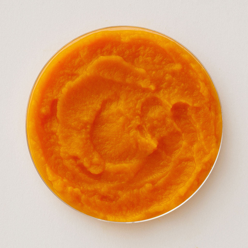 Fresh butternut squash in a glass dish, viewed from above.