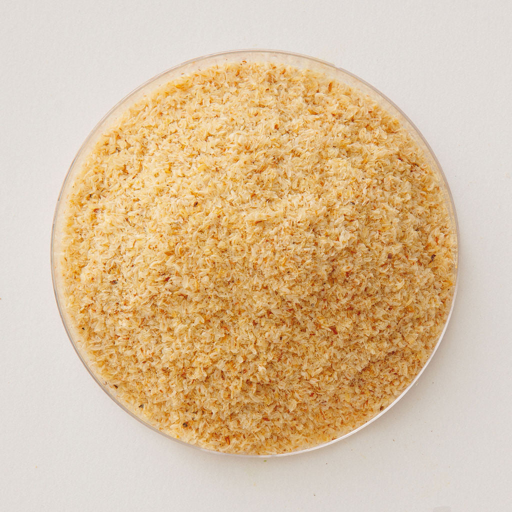 Psyllium husk in a glass dish, viewed from above.