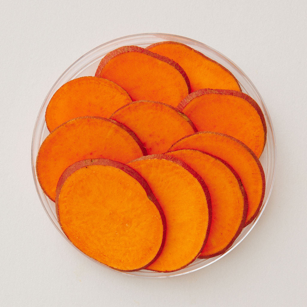 Fresh sweet potato in a glass dish, viewed from above.